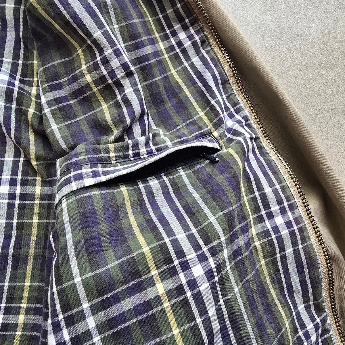 DEEP VINTAGE 90s Nautica Harrington jacket interior featuring a green, blue, and yellow plaid lining and zipper pocket