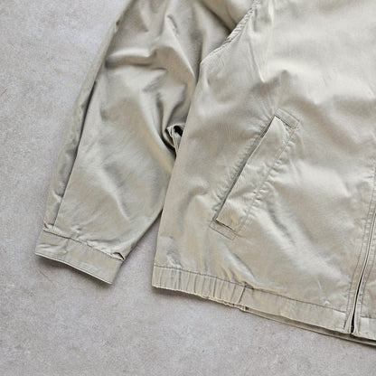 DEEP VINTAGE beige 90s Nautica Harrington jacket with a zip-up front and side pockets in good condition.
