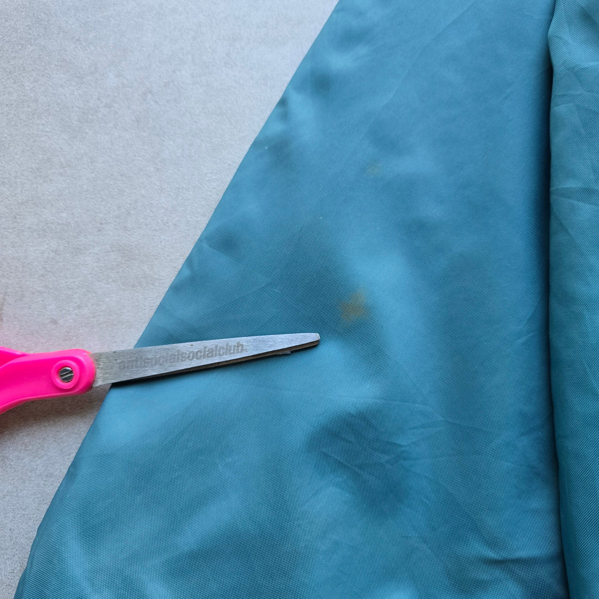 DEEP VINTAGE 90s Nike jacket sleeve showing small marks and signs of wear on the teal fabric