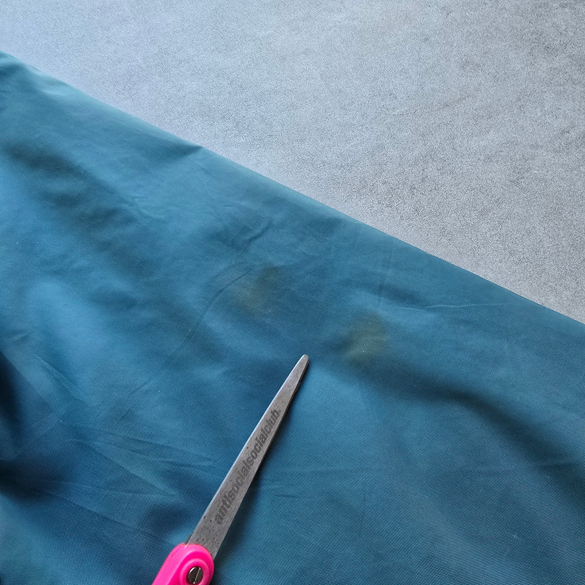 DEEP VINTAGE teal Nike jacket sleeve showing small marks and signs of wear