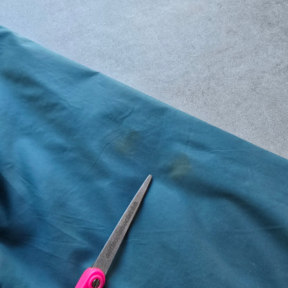 DEEP VINTAGE teal Nike jacket sleeve showing small marks and signs of wear